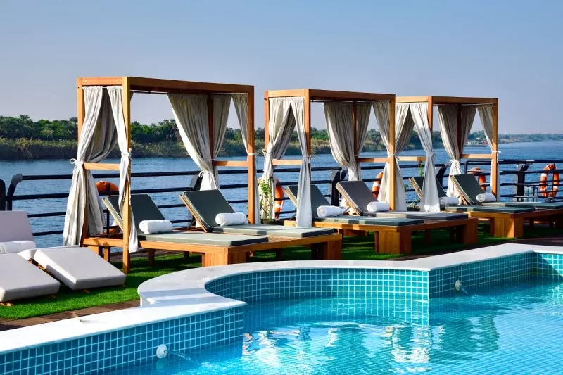 Relaxing on the sun deck of MS Mayflower Nile Cruise – pool, loungers and endless river scenery under open skies